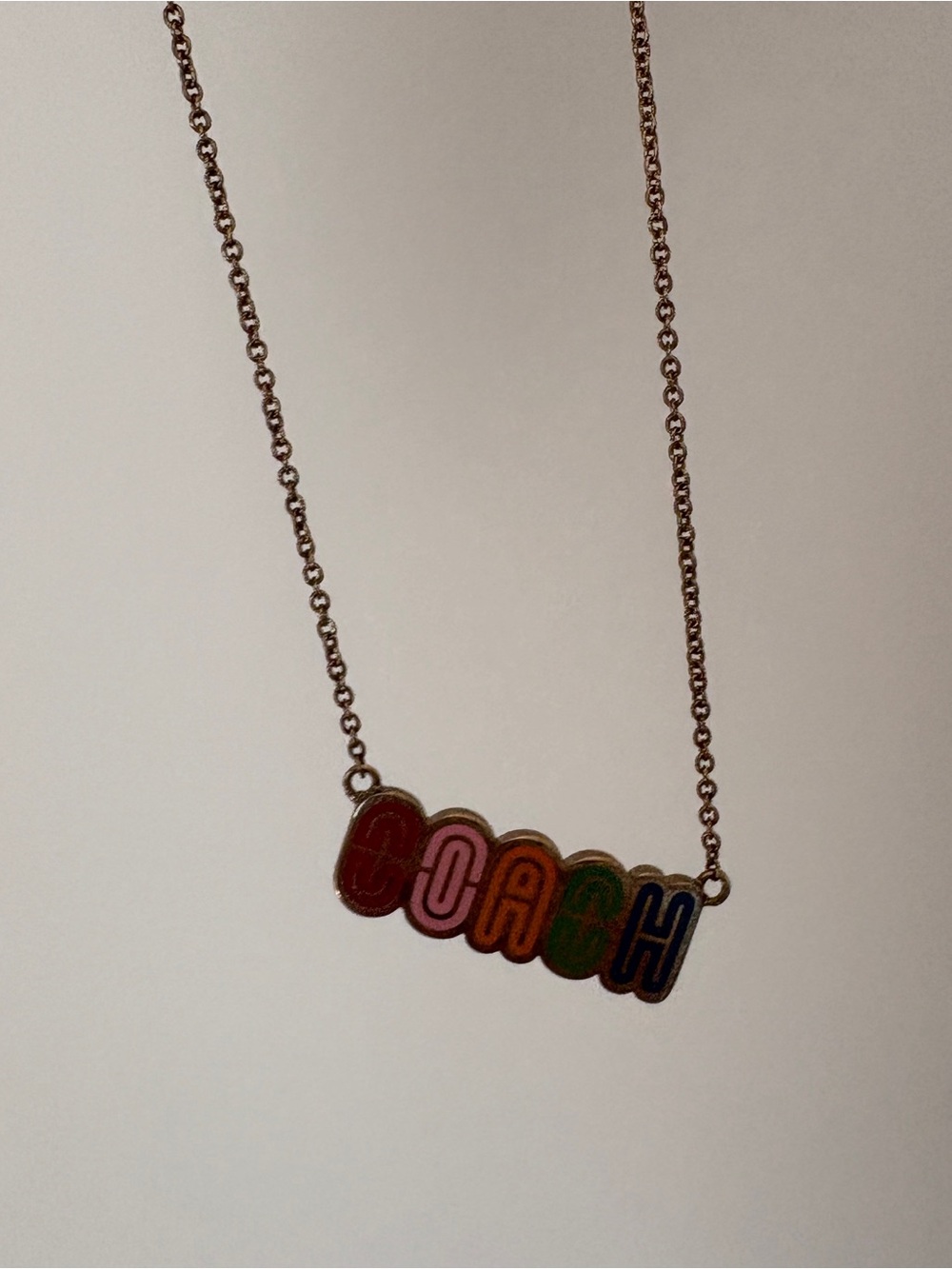 Coach Gold-Tone Necklace with Red, Pink, Orange, Green & Blue Enamel Letters